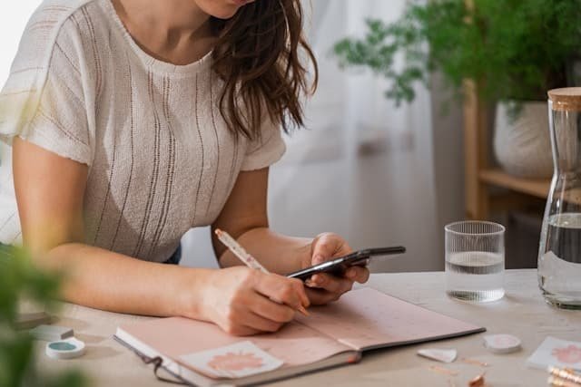 Femme notant son cycle sur un calendrier pour repérer son ovulation après une fausse couche